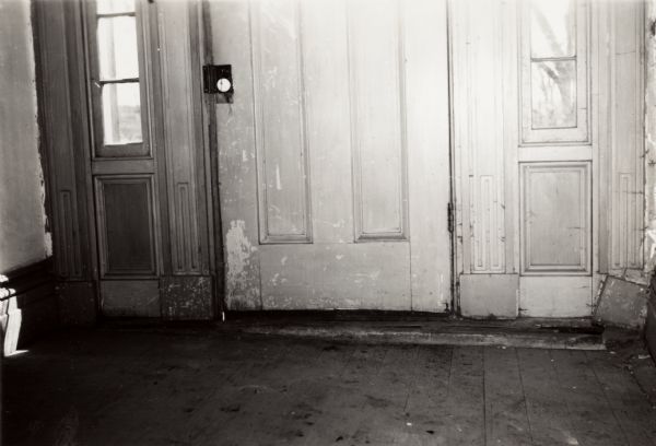 Interior view of the front door of the Charles A. Grignon House before restoration. The house was built between 1837 and 1839 of materials brought by water from New York.