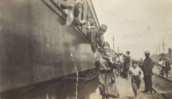 Send off for World War I recruits at the railroad station. The man leaning out of the train window is Ben Bergor, a professional magician and vaudeville performer.