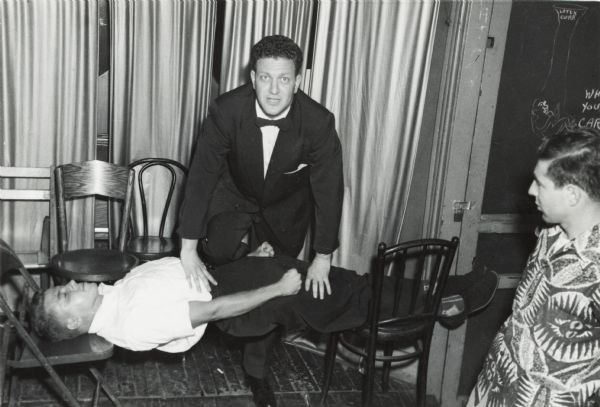 Dr. Morton Greene, a graduate psychologist, performing his hypnotism act.