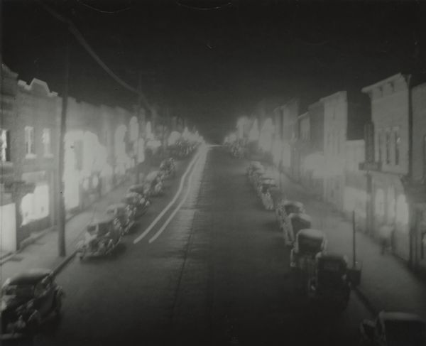 Elevated view of Silver Street in Hurley at 4:30 a.m., Sunday morning, showing busy street and all establishment's lights blazing. After the sweeping raid on many Hurley area establishments, on Tuesday, August 4th, the street was dark except for two restaurant signs. The arrest warrants were for gambling and prostitution.