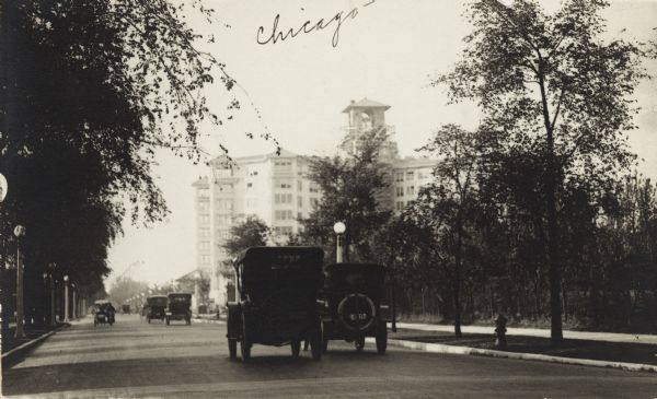 View down Sheridan Road, with automobiles on both sides. The Edgewater Beach Hotel is in the background.