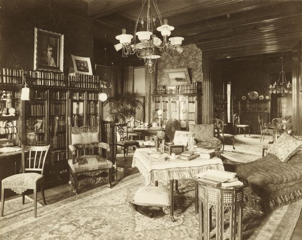 Library in the home of John Johnston (1836-1904), a successful Milwaukee banker, located at 645 Franklin Place, also known as "The Lion House." The dining room can be seen through a large doorway in the background.

The home was built in 1851 for Edward Diedrichs. Johnston purchased it from its third owner in 1896.  

