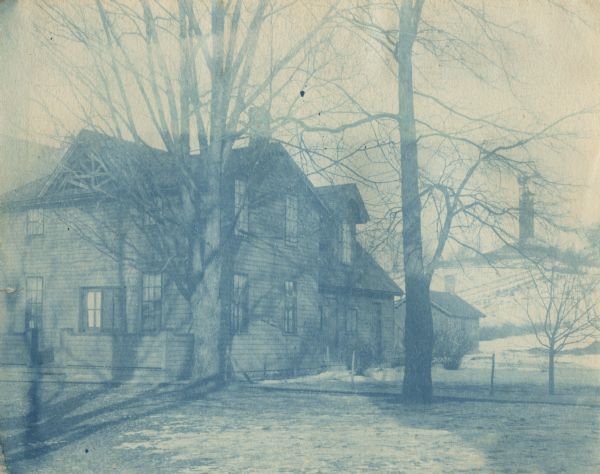 A cyanotype of the Home Cottage tipped into a commercially produced album of the Hillside Home School.