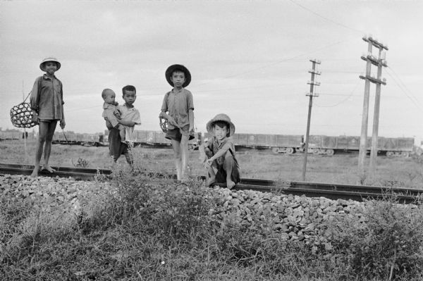 North Vietnamese children standing on the railroad track north of Hanoi.  The children were photographed by David Schoenbrun, an American journalist.