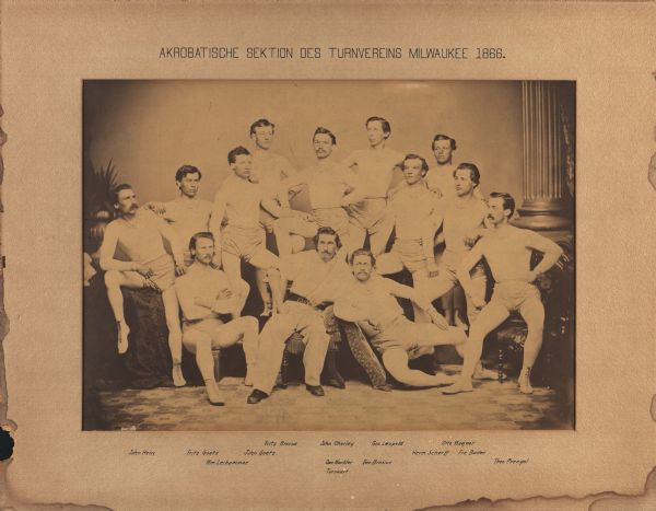 Acrobatic Gymnastics Club of the Milwaukee Turners, posing in a studio wearing their gymnastic clothing.