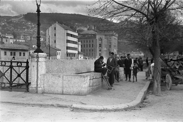 Wood carts and drivers on a street in Sarajevo, about a year before the city fell to the Germans.