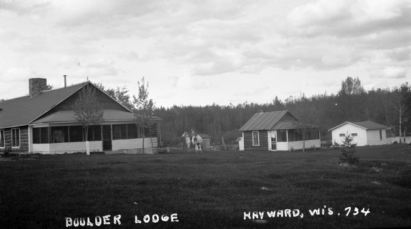 A woman sitting on a horse near cabins at Boulder Lodge.