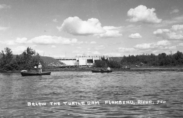 Men fishing out of wooden rowboats on the Turtle flowage near the Turtle Dam on the Flambeau River.