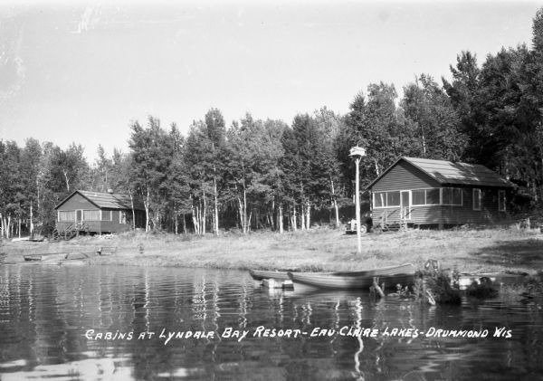 Cabins on shoreline of Upper Eau Claire Lake at Lyndale Bay Resort.