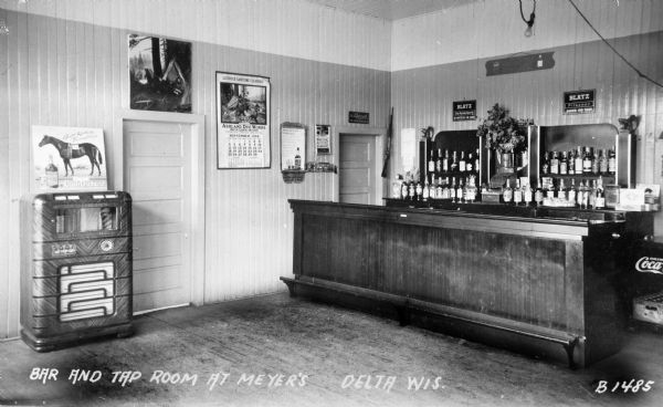 Interior of Meyer's Tavern, including stocked bar and jukebox.
