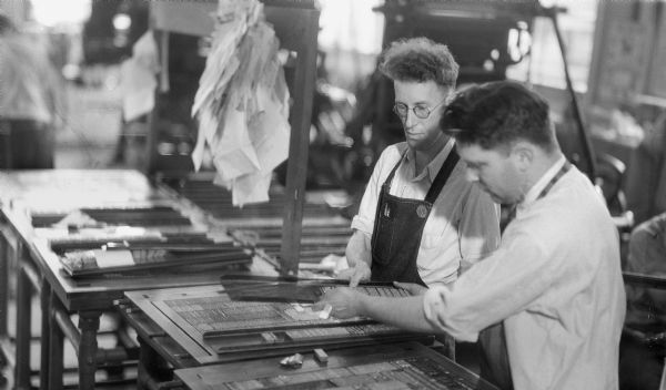 Two typesetters at work at the Daily Press.