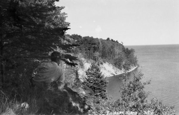 Man on Madeline Island cliff overlooking Lake Superior.