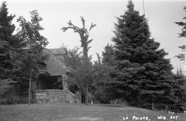 Two-story wood house with stone porch on Madeline Island.