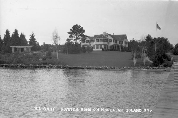Lakeside view from pier of large two-story house and grounds on Madeline Island.