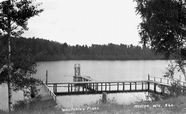 View of the lake shore and U-shaped dock at Whispering Pines.