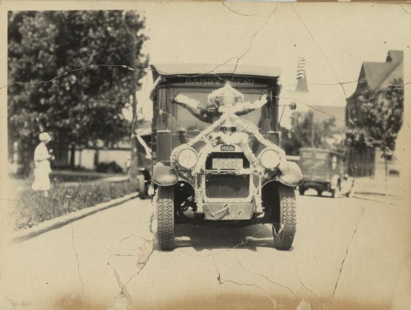 Front view of a truck decorated for a parade. Manufactured by the White Motor Company, used as a Bamby Bread delivery truck.