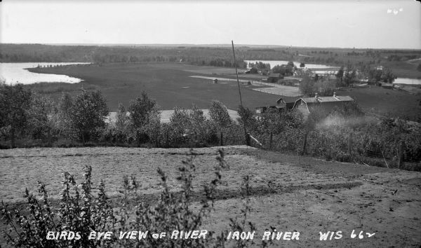 View from hill of Iron River winding through countryside of farms.