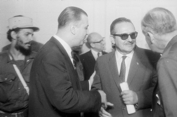 President Manuel Urrutia Lleó shaking hands with men in suits in Havana, Cuba during the celebration of the success of the Cuban Revolution.