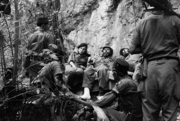 26th of July Movement soldiers resting by a cliff in Oriente Province during the Cuban Revolution. Vilma Espin in center.