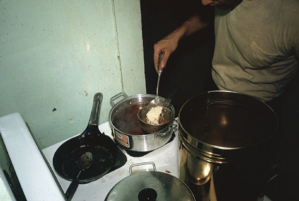 Member of the anti-Castro group Commandos L cooks ingredients for homemade explosive devices on a stove.