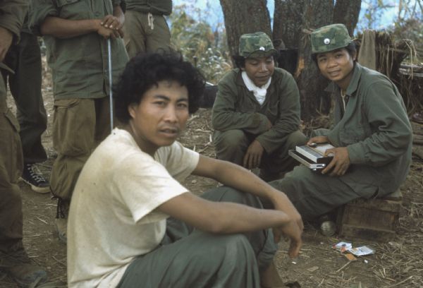 Colonel Bounchon's Lao infantrymen in the field listening to a small radio in the Luang Prabang vicinity, Laos.