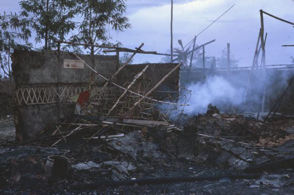 Smoking rubble in the village of Vin Quoi, Vietnam. Destruction caused by Viet Cong.