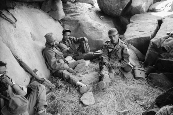 A group of Algerian National Liberation Front members sitting in a cave.