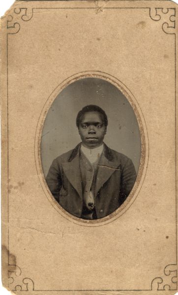 Tintype/ferrotype waist-up oval portrait of an African American man wearing a suit jacket, shirt, and partially buttoned vest.