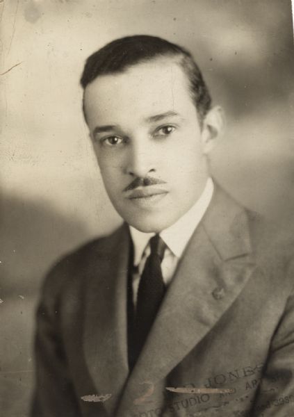 Quarter-length studio portrait of Henry H. Proctor Jr.? wearing a suit jacket, shirt, and tie.