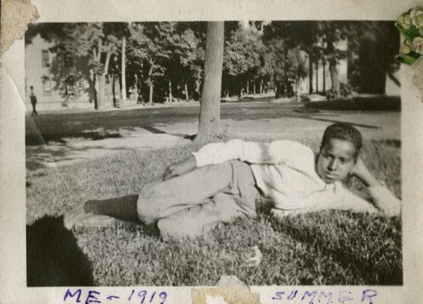 Andrew Webb Jr. reclining on the grass.