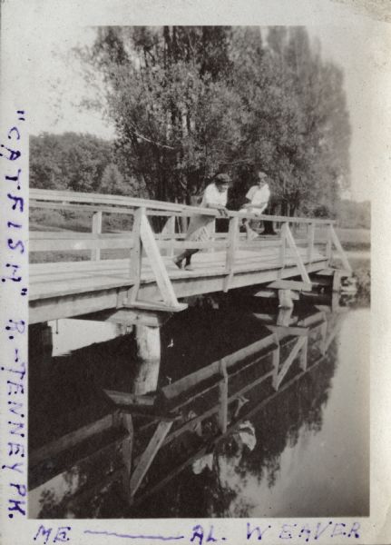 Andrew Webb Jr. and Al. Weaver standing on a bridge over the "Catfish" (Yahara) River in Tenney Park.