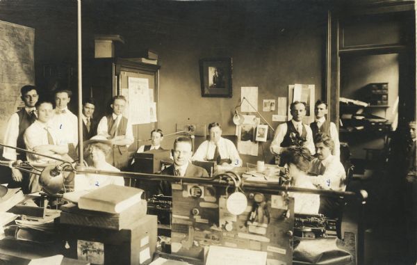 Staff of the "Evening Wisconsin" newspaper. Left to right: 1) Alvin Steinkopf, 2) Jessica Knowles, 3) John R. Wolf, and 4) Arthur Dering.