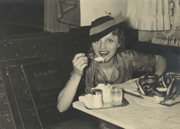 Irene Steinkopf, wife of Associated Press foreign correspondent Alvin J. Steinkopf and a former Milwaukee journalist, tastes her first Viennese coffee with whipped cream and rolls.