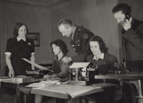 Employees of the Associated Press in Prague shortly after the end of World War II: left to right, Dashenka, Juta Turkova, Alvin Steinkopf (in his war correspondent's uniform), Fanny Spackova, and Bohumil Matlach.