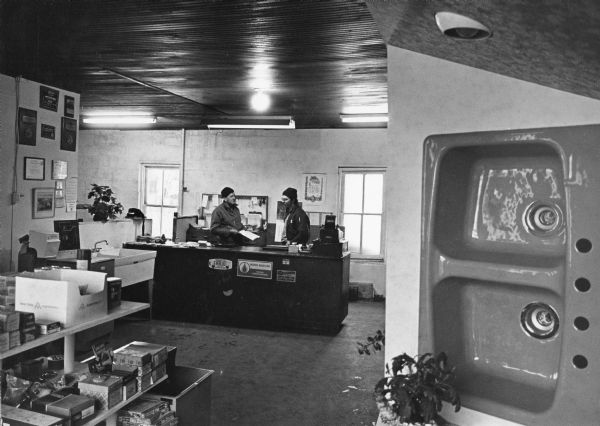 "Tri-County Plumbing & Heating, Inc. Almond Giese and Ralph Langenecker, proprietor, talk over a work project."