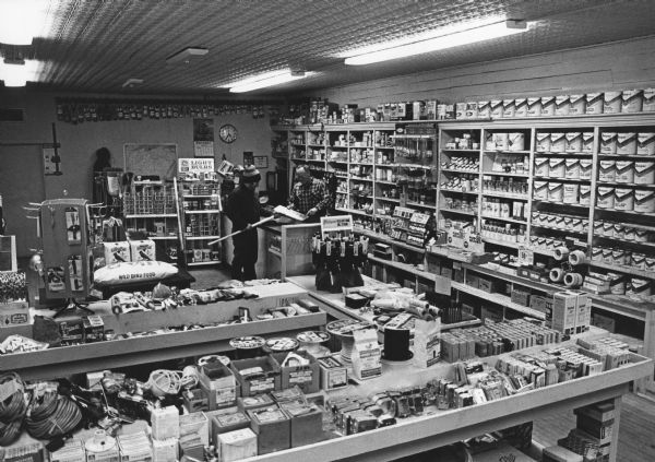 "Russ Bandlow Hardware. Russ purchased the building in 1950 and has operated the store since that time. His uncle, Arthur H. Bandlow, operated the store from 1935 to 1950. Ed Olsen preceded A.H. Bandlow in the business."