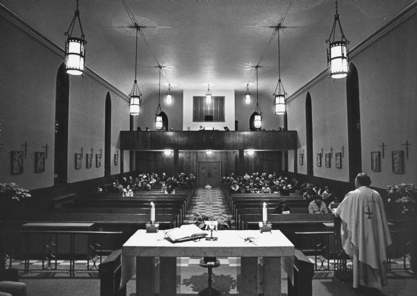 "Saturday night service at St. Theresa's Catholic Church.  Father Charles Loehr speaks to his congregation."