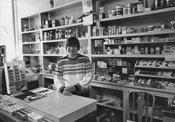 "The Mart. Mrs. Karl Hoff tends the drugstore in its 'Going Out of Business Sale.'"