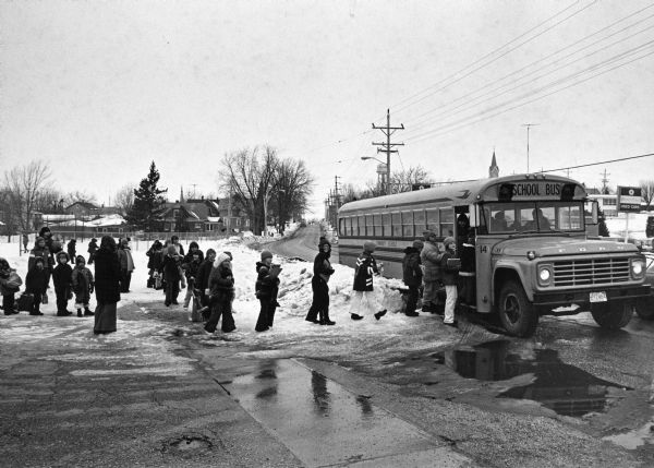 "School children boarding bus #14 after school."