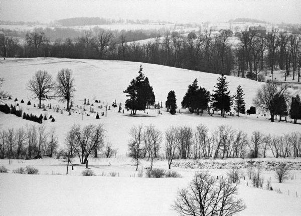 "The long lens compresses this view from the frozen Rock River in the foreground, the Catholic cemetery, and the Haag farm buildings in the distance."