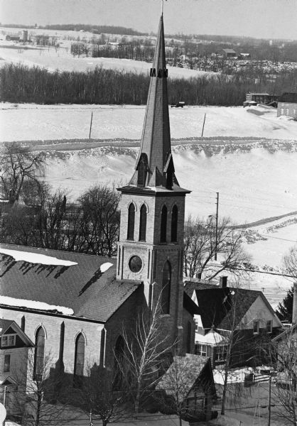 Elevated view of the town's elaborate brick church featuring a central steeple.