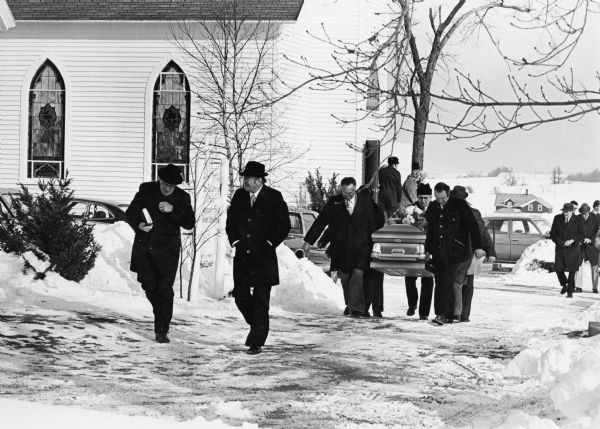 "Rev. Herbert Lemke and Charles Koepsell, Mayville, lead the mourners to the grave site."