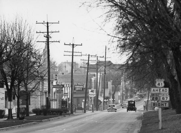 "Main (Milwaukee) Street. At this time Hwy 41 was still routed through the village."