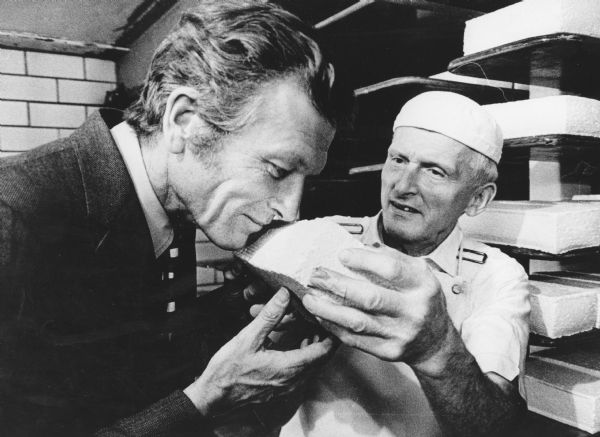 "This is a copy of a photograph taken by Milwaukee Journal staff photographer, Ernie Annheuser and was featured in that paper. Ralph Widmer lets Mayor John Lindsay smell some Brick Cheese."