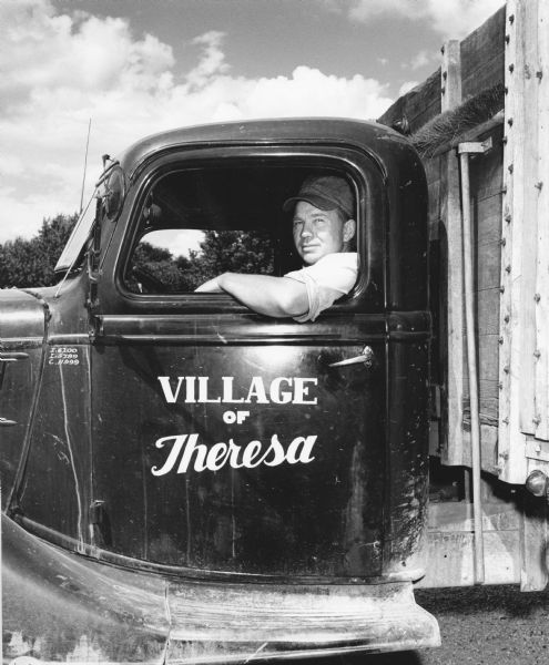 "Village man, Lawrence Steger, posed in the village truck."