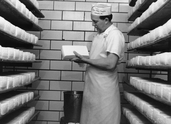 "Harvey Kamrath washes Brick Cheese at Widmer Cheese Factory."