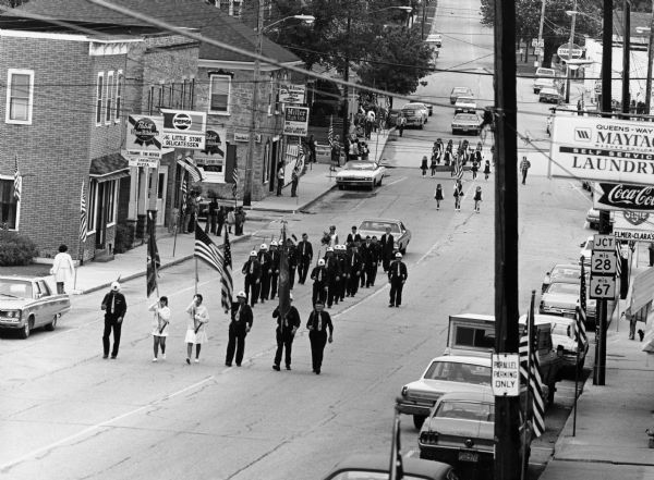 "American Legion members march up Main Street."
