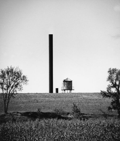 "The long lens captures the Baker Canning smokestacks, and water tower, on film."