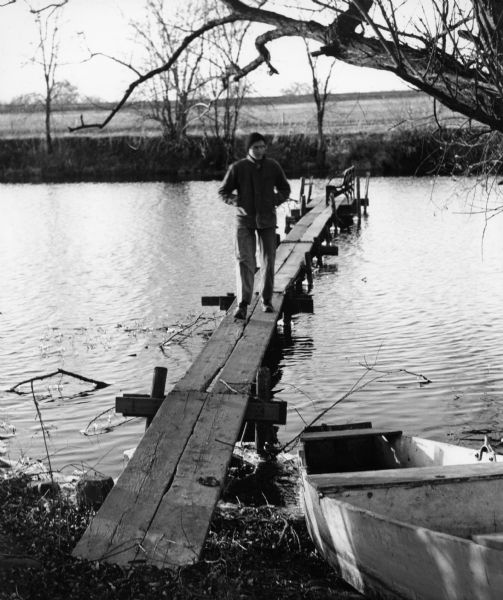 "Ralph Widmer checked out a pier on the Rock River." Ralph was the brother of photographer Jim Widmer.