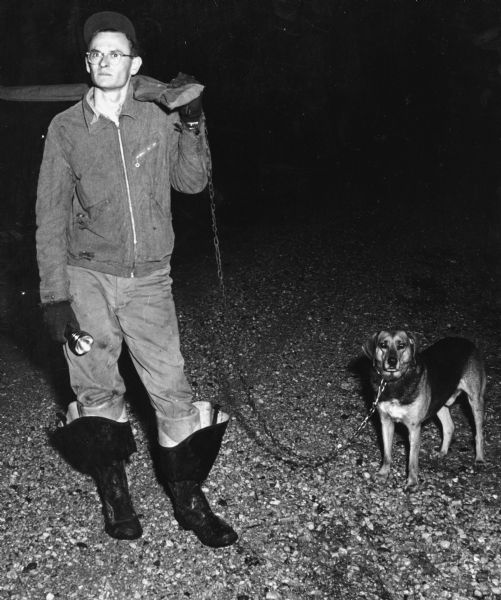 "Fred Zastrow and his dog Ranger prepare for an evening of coon hunting."